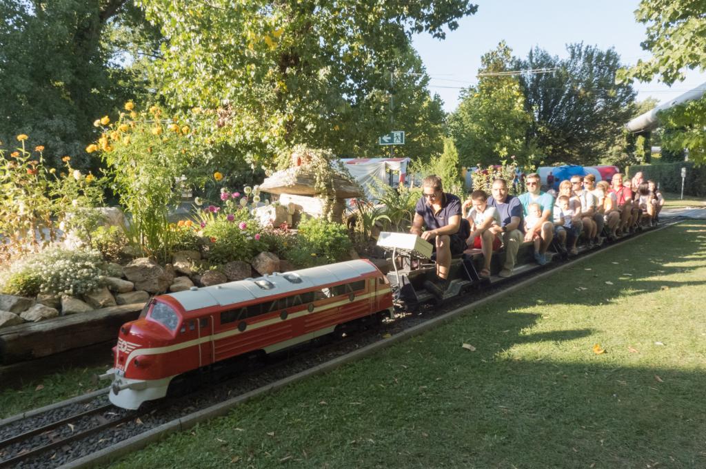 Personas viajan en vagones de tren miniatura en Museo del Ferrocarril húngaro en Budapest
